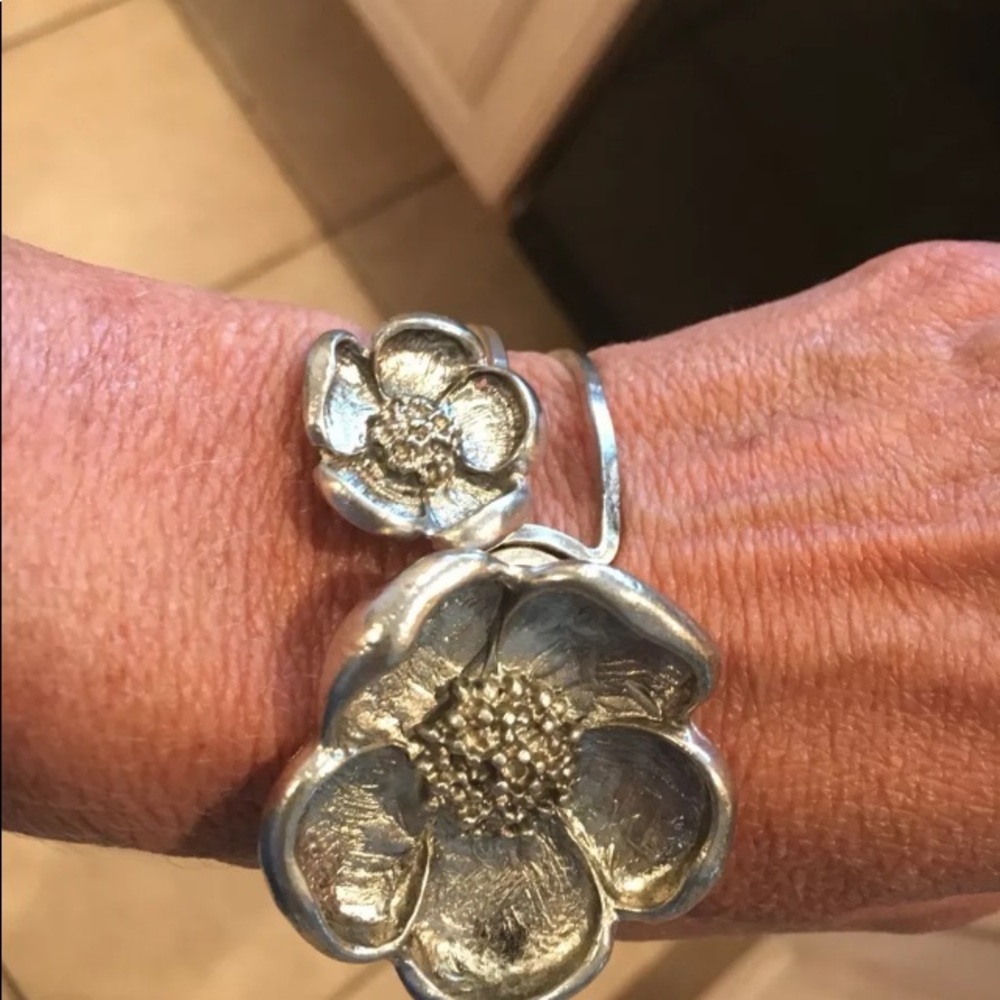 Silver bangle style bracket with 2 large flowers